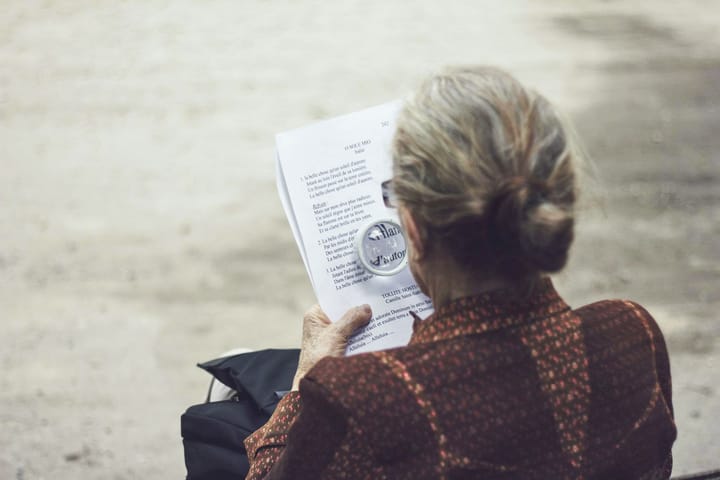 old age woman female reading sitting park bench Bengali News